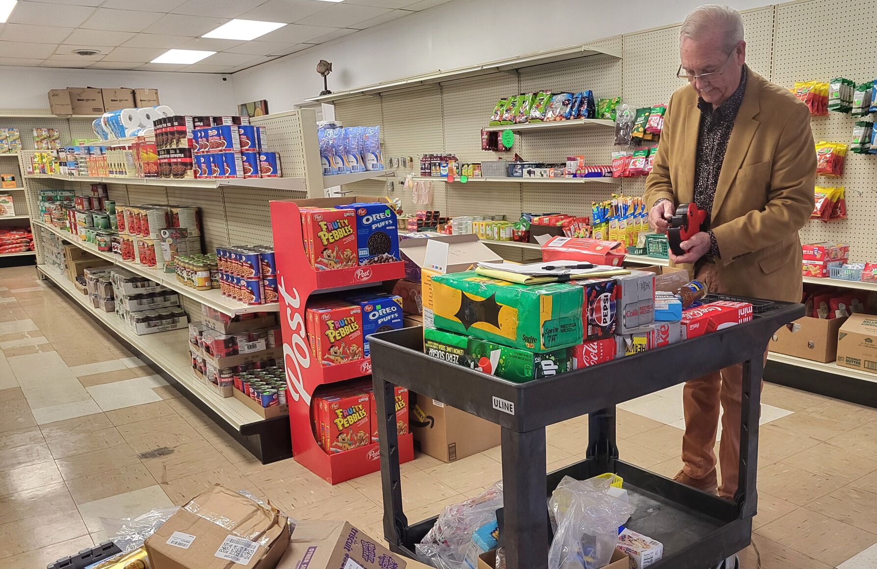 Brian Furry organizing inventory at Charleston Discount Grocery