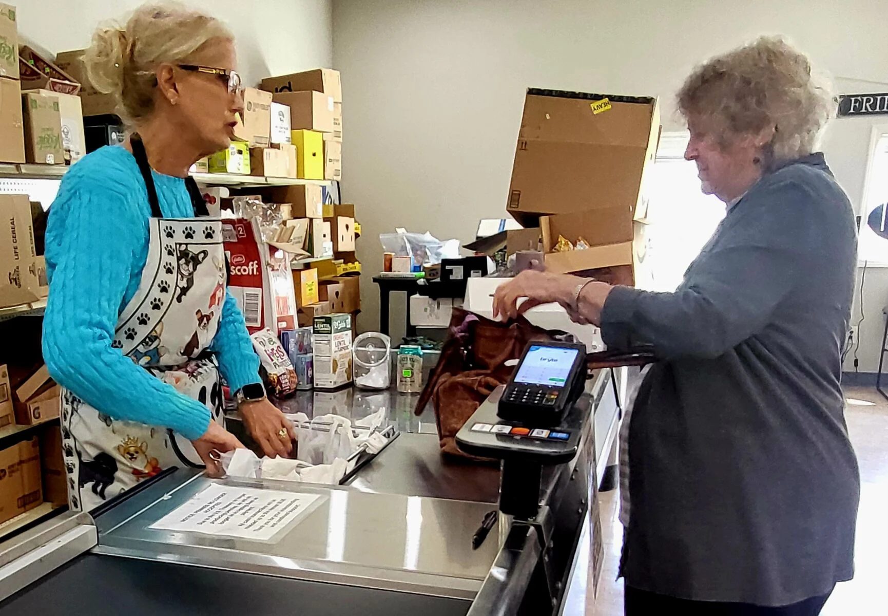 Becky Furry helping a customer at the register